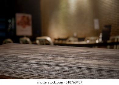 Empty Wooden Table Space Platform And Blurred Outdoor Restaurant Background For Product Display Montage.

