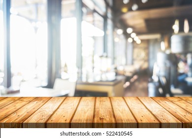 Empty wooden table space platform and blurred resturant or coffee shop background for product display montage