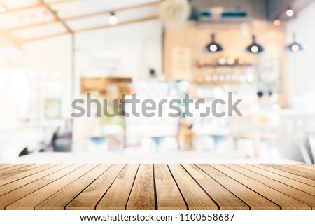 Empty wooden table space platform and blurred resturant or coffee shop background for product display montage