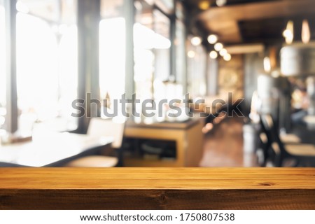 Empty wooden table space platform and blurred resturant or coffee shop background for product display montage