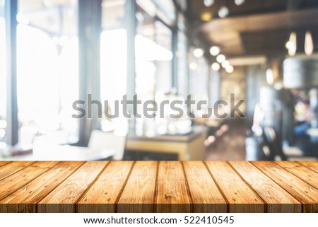 Empty wooden table space platform and blurred resturant or coffee shop background for product display montage