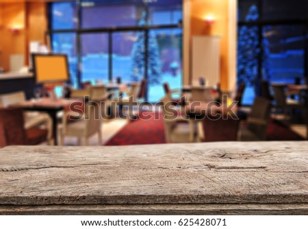 Empty wooden table space platform and blurred resturant or coffee shop background for product display montage