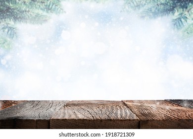 Empty Wooden Table Surface Over Blue Winter Background With Snow. Template For Product Display