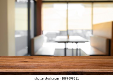 Empty Wooden Table Top With Blur Background Of Office And Meeting Room.