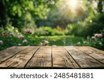 Empty wooden table top with blurred garden background for product display presentation or montage