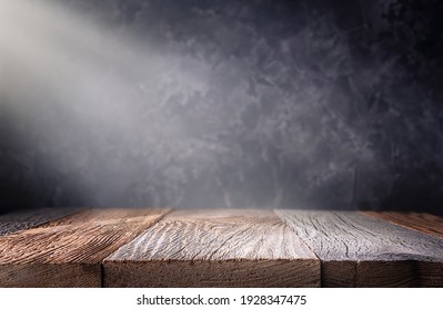 Empty Wooden Table Top With Defocused Dark Concrete Wall Background. Template For Product Display