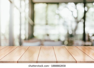 Empty wooden table top with lights bokeh on blur restaurant background. - Shutterstock ID 1888882858