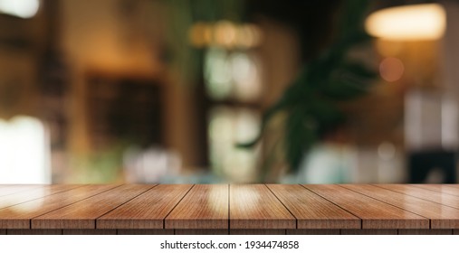 Empty wooden table top with lights bokeh on blur restaurant background. - Shutterstock ID 1934474858