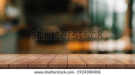 Empty wooden table top with lights bokeh on blur restaurant background. Stockfoto © 
