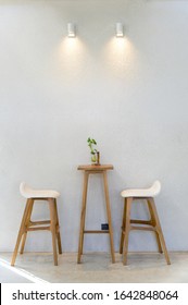 Empty wooden table with two stools
