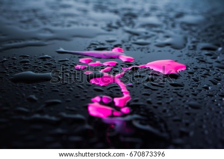 Empty wooden table with water drops against the background of autumn trees. The background is blurred. After the rain