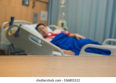 Empty Wooden Top On Blurred Of Patient And Healthcare After Surgery In The Recovery Room, Idea Health Care Background.