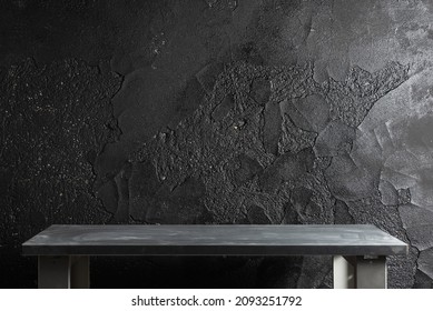 Empty workbench on the black wall background with copy space.