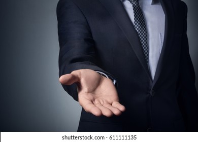 An empty workpiece.  A gesture expressing help, holding out a hand. Businessman stretches out his hand.