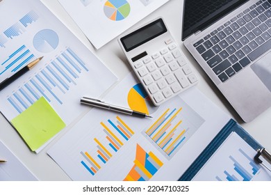 Empty Workspace, No People, Office Desk, With Laptop, Calculator, Graphs, Documents On The Table.