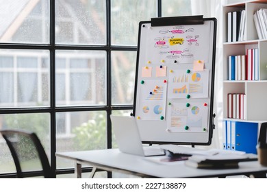 Empty workspace, no people, office desk, with laptop, calculator, graphs, documents on the table. - Shutterstock ID 2227138879