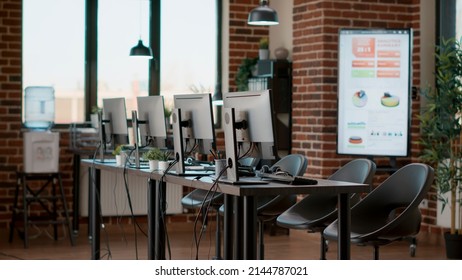Empty workstation with customer service technology on desk, offering telemarketing assistance to people. Telecommunication office with headphones and computers at call center. - Shutterstock ID 2144787021