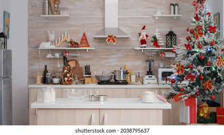 Empty Xmas Decorated Culinary Kitchen With Nobody In It Is Ready For Traditional Christmas Celebration. On Table Standing Traditional Homemade Cookie Dessert Ingredients With Milk Glass