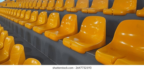 Empty Yellow Plastic Stadium Seats in Rows. Indoor Arena Seating, Sports Event Preparation, or Public Venue Concept. - Powered by Shutterstock - Get 15% off with code: PIKWIZARD15