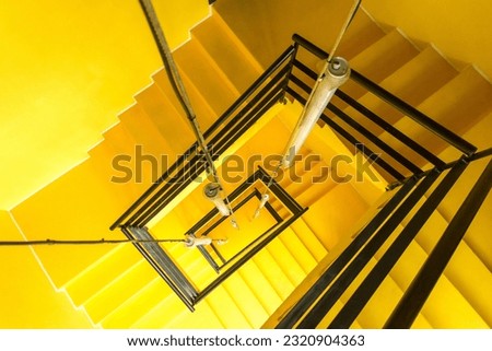 empty yellow staircase from above, with a wide viewing angle.