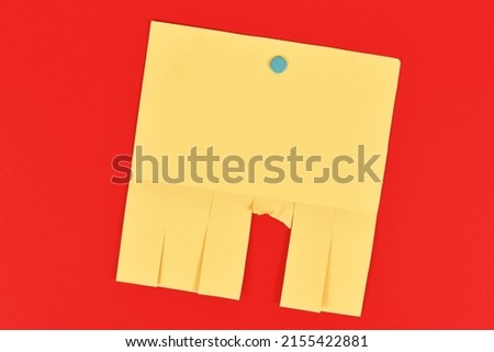 Empty yellow tear-off stub paper note without text on red background