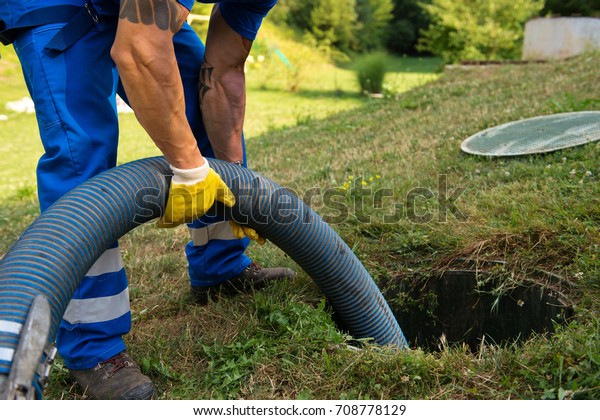 Emptying household septic tank. Cleaning sludge\
from septic system.