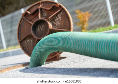 Emptying septic tank, cleaning the sewers. Septic cleaning and sewage removal. Emptying household septic tank. Cleaning sludge from septic system. - Shutterstock ID 616581983