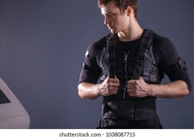 EMS, Portrait Of Handsome Man Near Electro Muscle Stimulation Machine