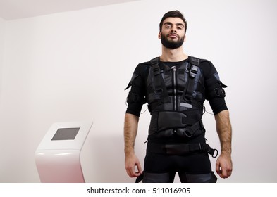 EMS, Portrait Of Handsome Man Next To Electro Muscle Stimulation Machine 