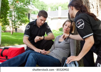 EMT medical professional asses a situation and measure vitals - Powered by Shutterstock