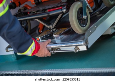 EMT Taking Out A Wheeled Stretcher From The Ambulance Car