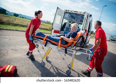 EMT team provide first aid on the street - Stock Image