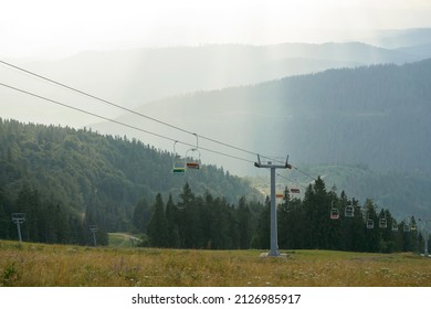 Emtpy Chairlift In Ski Resort. Shot In Spring With Green Grass And No Snow