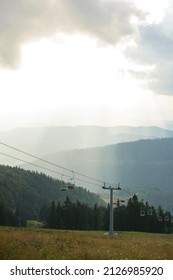 Emtpy Chairlift In Ski Resort. Shot In Spring With Green Grass And No Snow