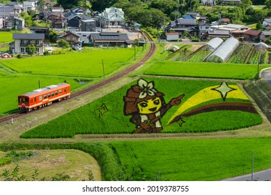 Ena, Gifu, Japan – August, 3, 2021 – Fireman Figure Created With Colored Rice Plants, Known As 