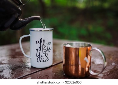 Enamel Mug With A Hell Yes Sign On It In The Outdoors Setting