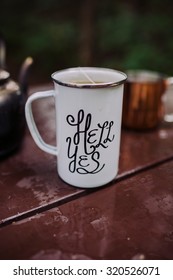 Enamel Mug With A Hell Yes Sign On It In The Outdoors Setting