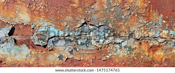 Enamelled  cracked  surface of the door hood of\
the old truck car was painted in yellow blue and red colors.\
Vintage texture panoramic\
concept