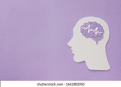 encephalography brain paper cutout on purple background,autism, Epilepsy and alzheimer awareness, seizure disorder, world mental health day concept