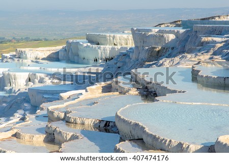 The enchanting pools of Pamukkale in Turkey. Pamukkale contains hot springs and travertines, terraces of carbonate minerals left by the flowing water. The site is a UNESCO World Heritage Site.