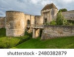 An enchanting view of the historic Castle of Caen in Normandy, France, with Saint Pierre Church in the background, showcasing medieval architecture.