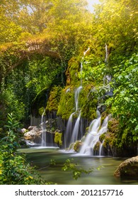 Enchanting Waterfall Surrounded By Nature With Fairytale Lighting