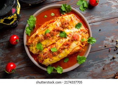 Enchilada With Beef With Tomato Sauce On Wooden Table, Mexican Kitchen Top View