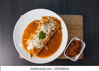 Enchilada With Fried Beans On A Plate