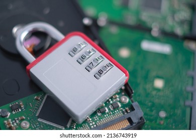 Encrypted hard disk. Padlock with cipher on an opened hard disk. Data loss. computer motherboard. the concept of data, hardware, information technology and cyber security.