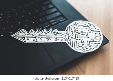 encryption key icon made of circuits and LED lights on top of laptop keyboard, concept of digital security or data encryption