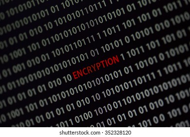 'Encryption' word in the middle of the computer screen surrounded by numbers zero and one. Image is taken in a small angle. 