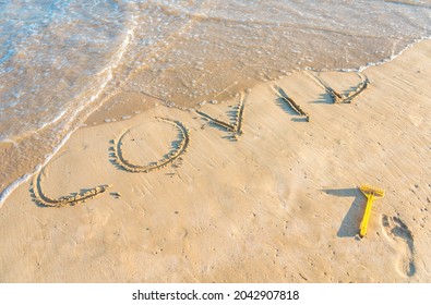 The End Of Covid. A Wave Is Wiping Out The Word COVID Written On The Sand Of A Beach, As A Symbol Of The Nightmare Of This Pandemic Is Getting To The End.