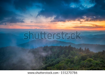 The end of the day brings the distant light across the Appalachian  Mountains on the Blue  Ridge Parkway in Western North Carolina.