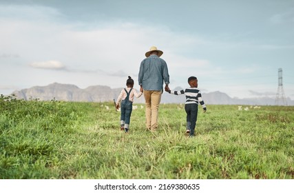 At The End Of The Day Its Family Who Matters. Rearview Shot Of A Man And His Two Adorable Children Exploring A Farm.